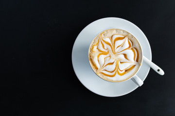 Latte art cup on black background