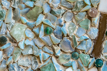 Phetchabun, Thailand - February 23.2017: Buddha statues and colored foot path colorful glass stacked in Wat Pha Kaew, Khao Kho, Phetchabun at Thailand.