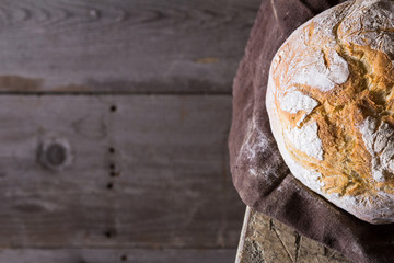 Freshly baked traditional bread on wooden table