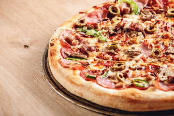 Italian pizza with cheese and olives macro. Pizza with mozzarella, olives and basil top view with copy space