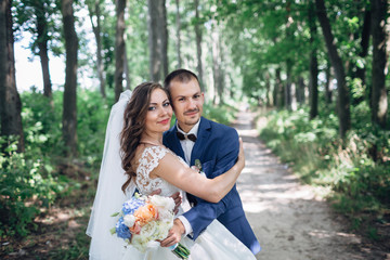 The charming brides embracing in the park