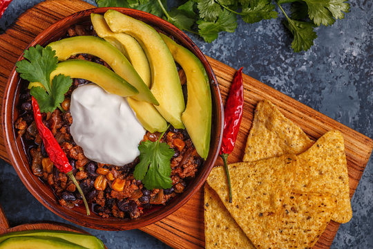 Chili Con Carne In Bowl With Avocado And Sour Cream.