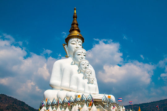 Phetchabun, Thailand - February 23.2017: Buddha statues and colored foot path colorful glass stacked in Wat Pha Kaew, Khao Kho, Phetchabun at Thailand.