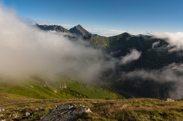 Panorama of summer mountains under the clouds