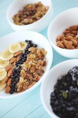 Healthy breakfast. Oatmeal with banana, almond nuts, blueberries and raisins.