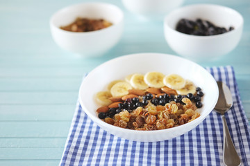 Healthy breakfast. Oatmeal with banana, almond nuts, blueberries and raisins.