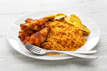 jollof rice with chicken and fried plantain, west african cuisine