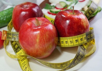 Diet - slimming .Weight loss concept with red apple, vegetables and dairy products
