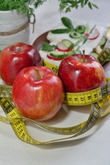 Diet - slimming .Weight loss concept with red apple, vegetables and dairy products
