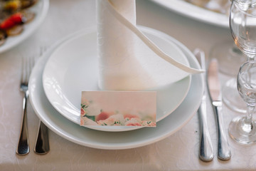  white napkin and pink card lying on a plate