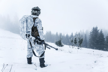 Winter arctic mountains warfare. Action in cold conditions. Sniper with weapons © Getmilitaryphotos
