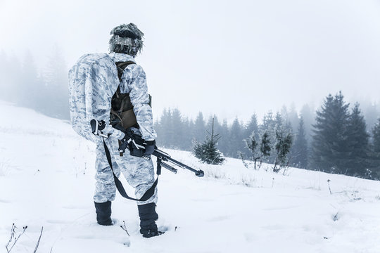 Winter arctic mountains warfare. Action in cold conditions. Sniper with weapons
