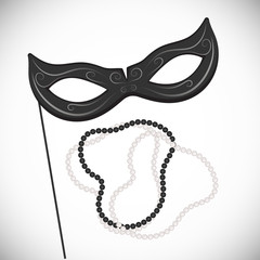 Carnival mask on a stick. Black and white pearl necklace. Mardi Gras
