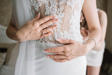Obraz na płótnie Canvas bride touching her beautiful and gentle wedding dress