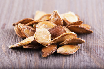 Pumpkin seeds over wooden table