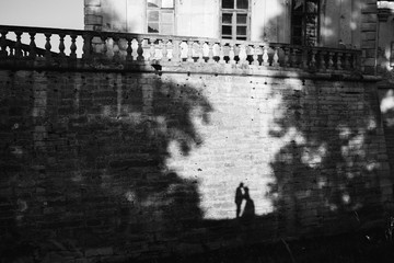 shadow on the wall of the bride and groom who kissing