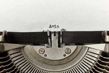 Asia typed words on a vintage typewriter