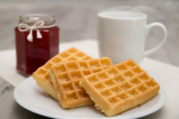 Waffles with berry jam and hot tea