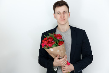 Young man with tulip bouquet, white background