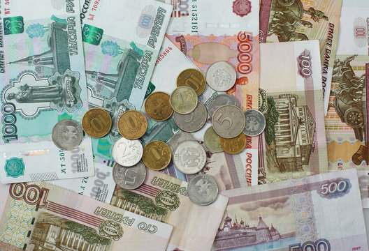 Banknotes and coins coins of different denomination arranged disorderly