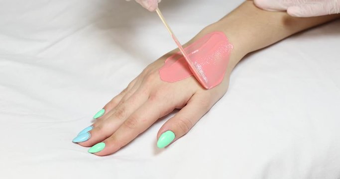 Process depilation female legs and hands in a beauty salon 