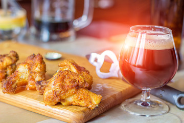 Chicken pieces on the grill and beer.