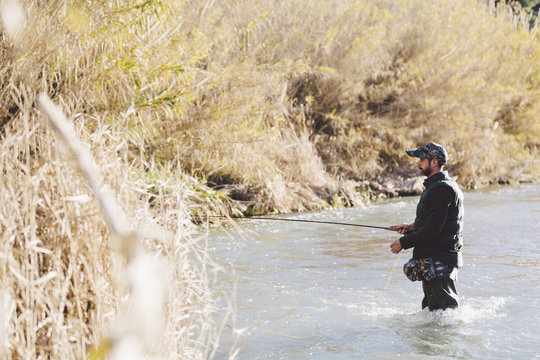 The fisherman holding a rod