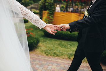 The charming brides walking along alley