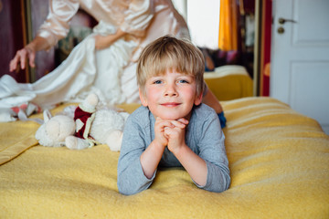 Fototapeta premium Cute handsome boy (5 years) lying on the bed.