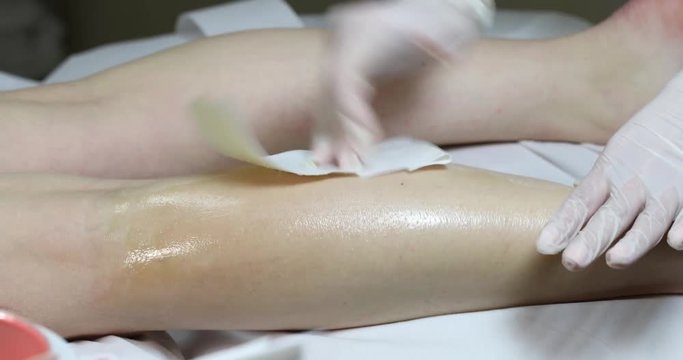 Process depilation female legs and hands in a beauty salon 
