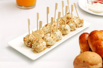 Cheese balls breaded and fried with bamboo sticks.