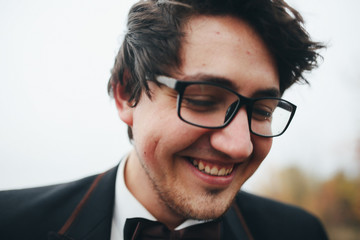 The handsome groom walking along shore