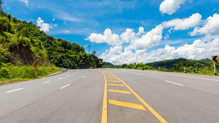Winding Paved Road with blue sky in the mountain.