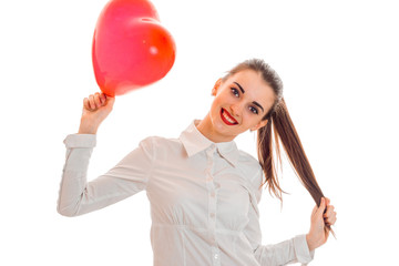 cheerful brunette woman in love posing with red heart baloon in her hands isolated on white background