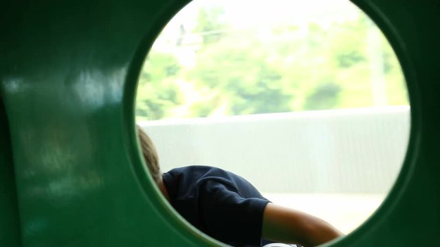 Child on a highs speed train. Young boy inside circule while on a moving train