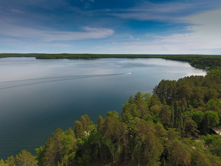A ski boat cruising along making waves on Presque Isle lake. Summer of 2016 Presque Isle Wisconsin