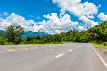 Winding Paved Road with blue sky in the mountain.