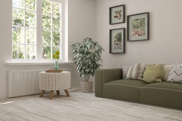 White room with sofa and green landscape in window. Scandinavian interior design