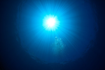 Sunburst and bubbles on the ocean surface