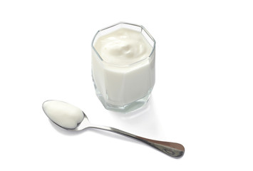glass of natural yoghurt and spoon isolated on white background