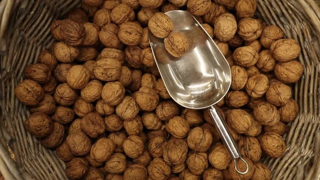 Grocery walnuts. Copper shovel and walnuts in the background