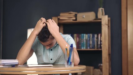 Upset schoolboy doing homework