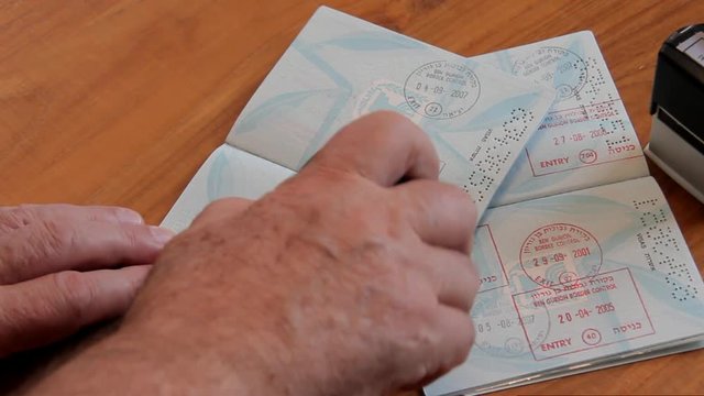 Police Officer Puting a Stamp in the Passport