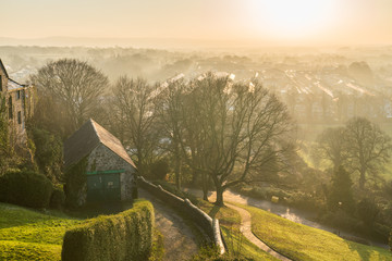 Foggy sunset view from Clitheroe Castle into the valley.
