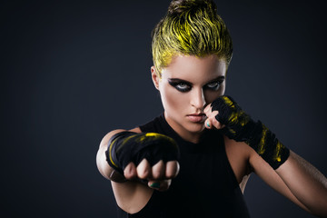 Woman mma fighter with yellow hair