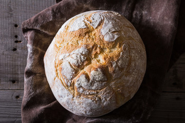 Freshly baked traditional bread on wooden table