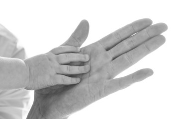 Baby holding father's hand