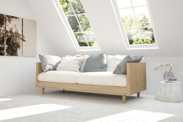 White room with sofa and green landscape in window. Scandinavian interior design