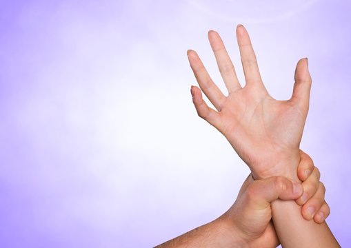 Composite image of Hands retaining against purple background 