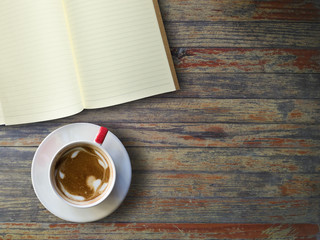 Blank book and hot caffee on old wooden table